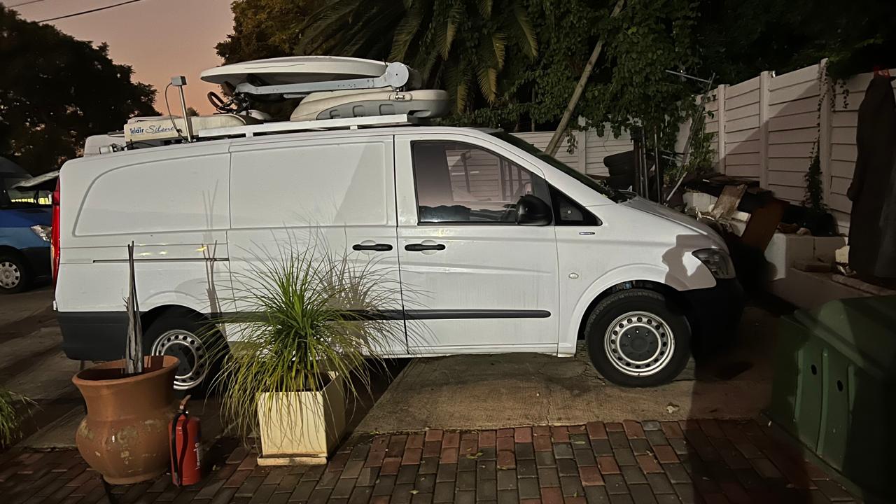 Compact white DSNG van with a roof-mounted stowed satellite antenna